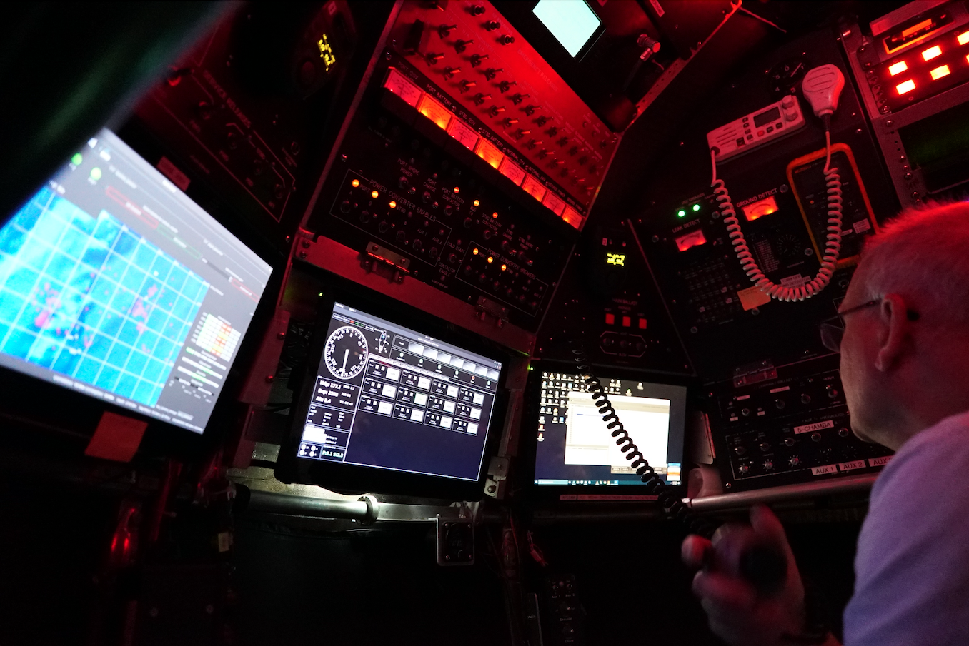 Alvin pilot at instruments, red interior lighting