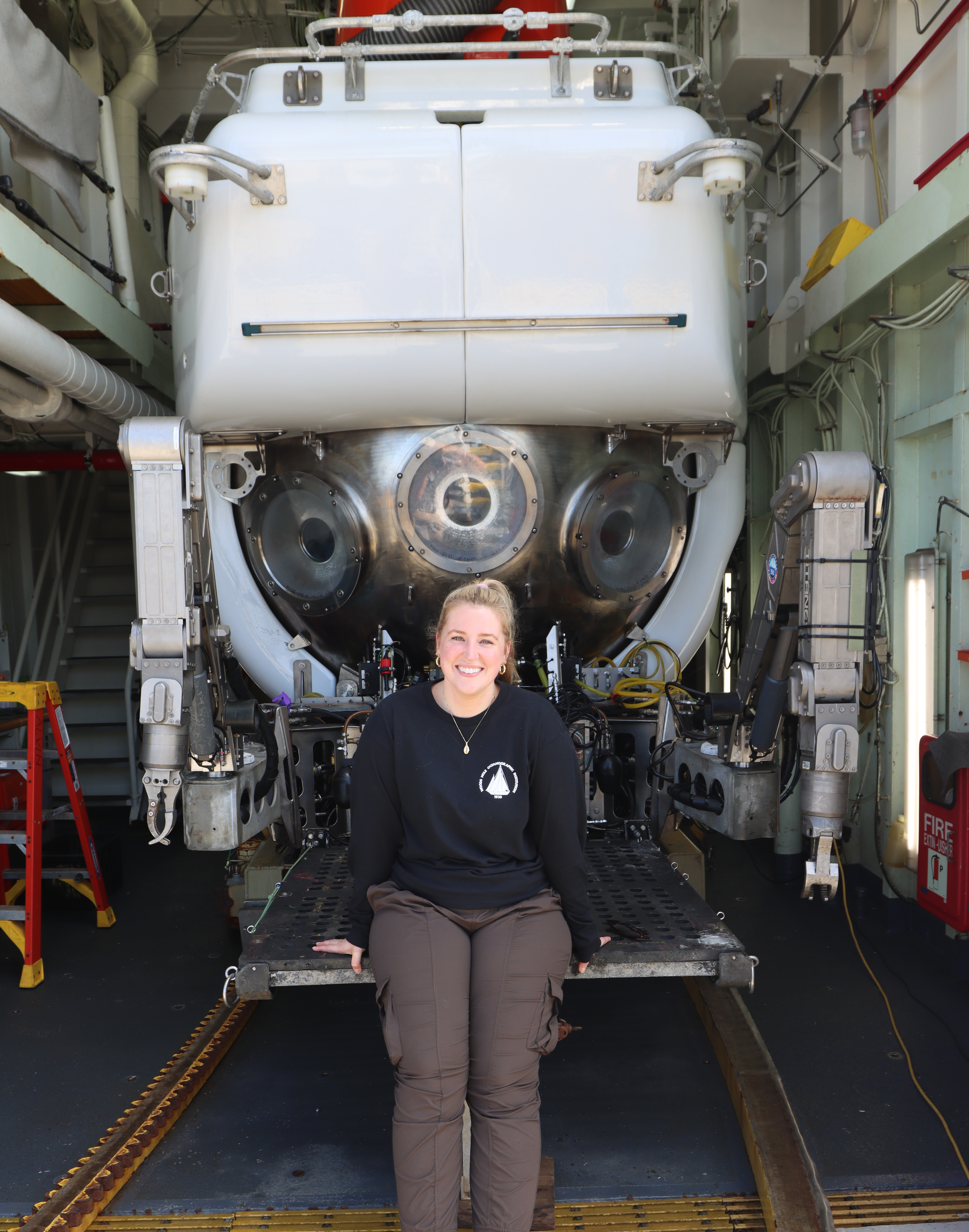 Megan Davies seated in front of DSV Alvin